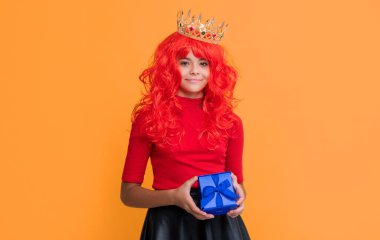 positive child in crown with present box on yellow background.