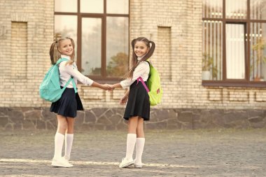 two school pupils best friends together outdoor.