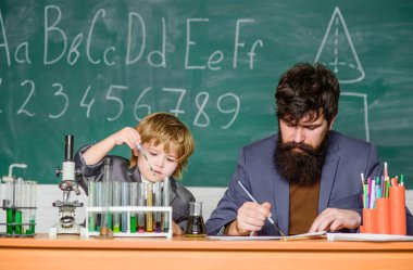 Studying is interesting. Personal example and inspiration. Study educational activity through experience. I love study in school. Teacher and boy in chemical laboratory. Study chemistry and biology.