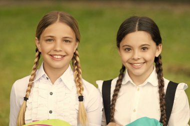 schoolgirl portrait. two smiling teen children schoolgirls outdoor. friendship of schoolgirls.