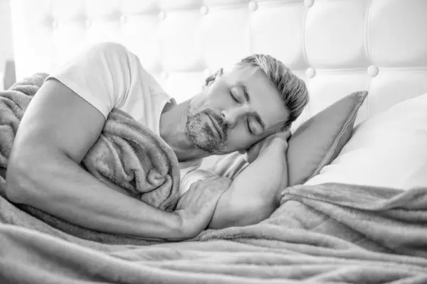 stock image mature guy sleeping in bed. early morning.