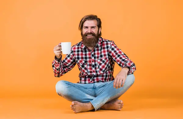 happy bearded man drinking morning coffee. man drink hot tea from cup. good morning to you. energetic warm beverage. need some coffee for inspiration. perfect start of the day.