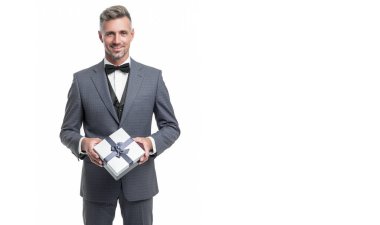 cheerful man in blue suit with gift box isolated on white. valentines day.