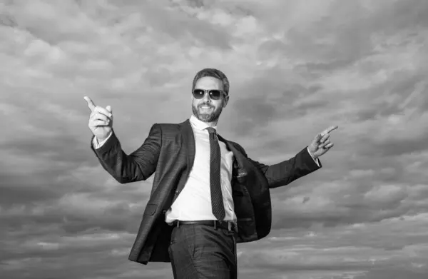 happy businessman in business suit. photo of businessman in suit. businessman in suit on sky background. businessman in suit outdoor.