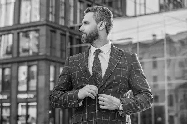 caucasian entrepreneur wearing jacket in the street. photo of entrepreneur with tie. entrepreneur outdoor. entrepreneur on urban background.