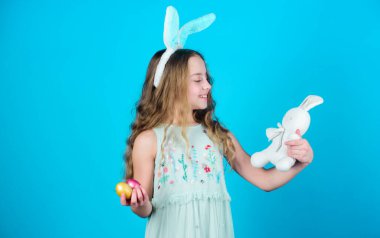 Paskalya tavşanı geliyor. Paskalya tavşanı. Küçük kız ve tavşan oyuncağı. Paskalya oyuncağıyla tavşan kulaklı küçük bir kız. Paskalya tavşanı tarzı oyuncaklarla oynayan küçük bir çocuk. Güzel oyuncaklı küçük bebek..