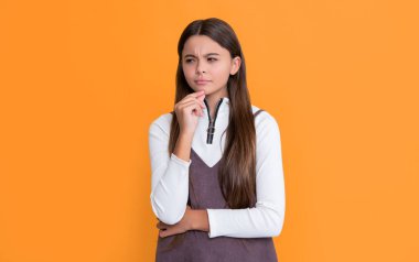 thinking child with long hair on yellow background.