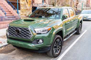 New York City, USA - March 15, 2024: 2021 Toyota Tacoma TRD Sport V6 car green color parked outdoor, corner view. clipart