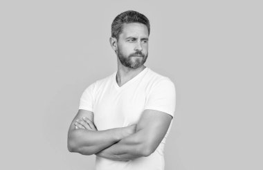 Sıradan giyinen yakışıklı adam. Sıradan gömlekli sakallı adam sarı arka planda izole edilmiş. Stüdyoda sıradan bir adam. Beyaz gömlek giyen beyaz bir adamın fotoğrafı..