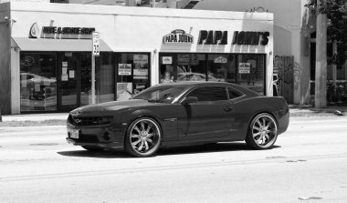 Miami Beach, Florida USA - April 15, 2021: red Chevrolet Camaro SS 2019 muscle car, side view.