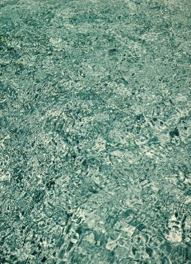 turquoise color background of swimming pool water with ripples in mediterranean.