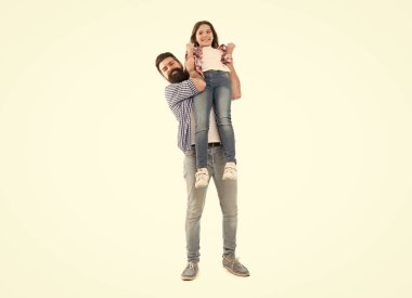 A darling daughter of her dad. Bearded man carrying small daughter child in his hands. Happy father and little daughter enjoying time together. Treating his daughter with love.