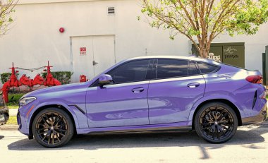 Miami Beach, Florida USA - April 15, 2021: parked blue bmw x6 sdrive 40i, side view.