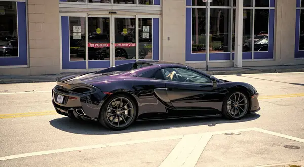 Miami Beach, Florida USA - April 15, 2021: mclaren 570GT MSO Black Collection, back side view.