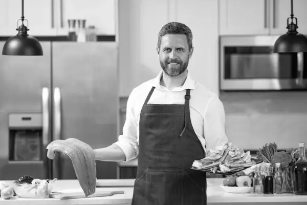 stock image chef with lobster and salmon seafood. chef cooking lobster and salmon seafood. chef with lobster and salmon seafood in the kitchen. happy chef with lobster and salmon seafood.