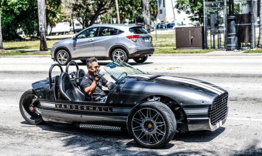 Miami Beach, Florida USA - April 15, 2021: vanderhall tree wheeled venice roadster tricycle, side view.