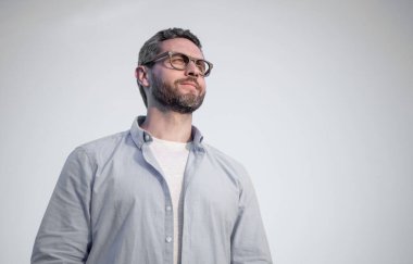pensive thoughtful man standing peaceful. pensive man in glasses outdoor. pensive man on sky background.