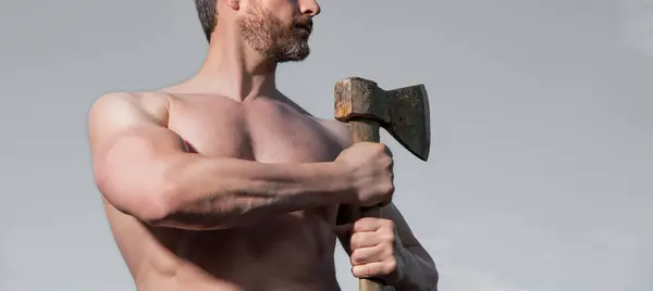 stock image shirtless male with axe. caucasian male hold ax. brutal male on sky background.