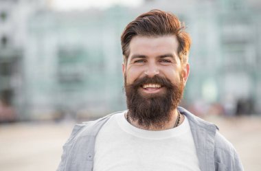 happy bearded man walk outside. face of man with beard. brutal casual man outdoor.