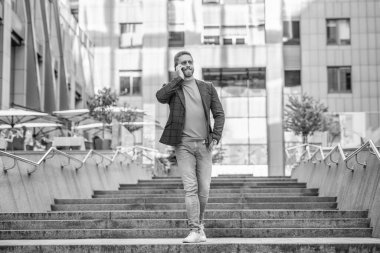 Adamın cep telefonuyla dışarıyı aratıyor. Sokakta cep telefonu arayan bir adam var. Dışarıdaki cep telefonundan arayan bir adam. Bağlantı adamı cep telefonundan ara ve konuş..