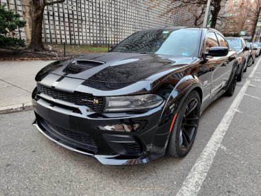 New York City, USA - March 01, 2024: 2020 Dodge Charger SRT Hellcat automotive brand car parked in the street, angle view. clipart