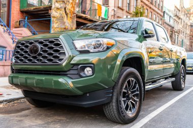 New York City, USA - March 15, 2024: 2021 Toyota Tacoma TRD Sport V6 car green color parked outdoor, low view. clipart
