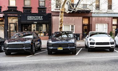 New York, ABD - 15 Mart 2024: Porsche Cayenne ağaç arabaları, ön manzara.