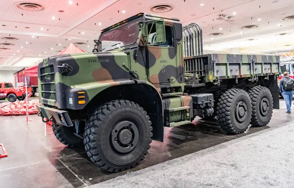 stock image New York City, USA - March 27, 2024: Oshkosh AMK23 MTVR 7 military cargo truck at New York International Auto Show, side view.