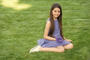 girl sitting on grass. happy teen girl. teenager girl outdoor.