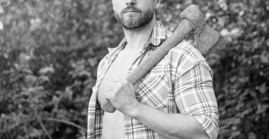 Çiftlik sahibinin baltalı dış görünüşü. Çiftlik sahibinin baltayla fotoğrafı. Baltalı çiftçi. Baltası olan, kareli gömlek giyen bir çiftlik sahibi..