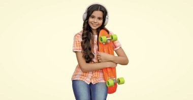 teen girl with skateboard. leisure. stylish girl with skateboard isolated on white. Childhood lifestyle. Summer skateboarding activity. Skateboarder girl in skate park. relax after skateboarding. clipart