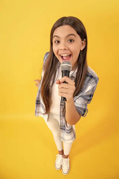 stock image teen interviewer of gen z. interviewing for her blog. amazed teen girl blogger interviewing with microphone. young interviewer girl making interview. teen school interview. interview online.