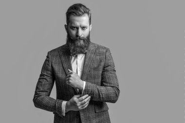 tuxedo formal man isolated on grey with copy space. tuxedo formal man in studio. tuxedo formal man on background. photo of tuxedo formal man with beard.