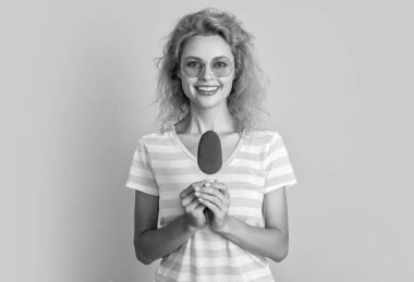 glad girl with icecream in studio. girl with icecream on background. photo of girl with icecream at summer. girl with icecream isolated on yellow. clipart