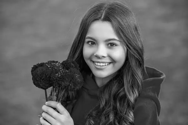 stock image glad teenager girl with autumn bouquet outside. photo of teenager girl with autumn bouquet. teenager girl with autumn bouquet outdoor. teenager girl with autumn flower bouquet.