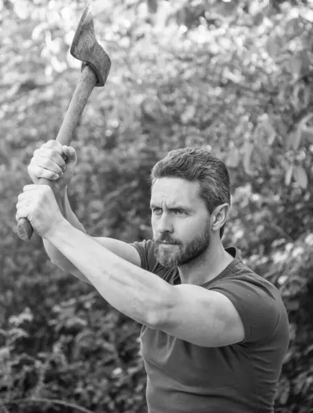 stock image caucasian man hit with axe outdoor. photo of man hit with axe. man hit with axe. man hit with axe wearing shirt.