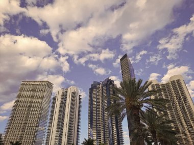 High-rise buildings modern urban architecture on cloudy sky in Sunny Isles, USA. clipart