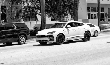 Miami Beach, Florida USA - April 15, 2021: 2019 white Giallo Auge Lamborghini Urus, corner view.