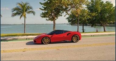 Miami Beach, Florida USA - April 15, 2021: red Ferrari SF90 Stradale, side view. luxury sport car. clipart