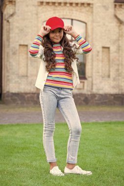 positive teen girl model keeping arms crossed. teen fashion style. teen child standing outdoors.