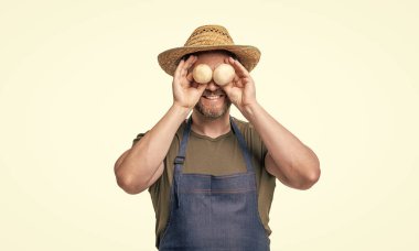 greengrocer in apron and hat with mushroom vegetable isolated on white.