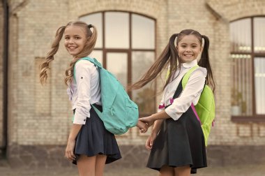 happy two school girls best friends together outdoor.
