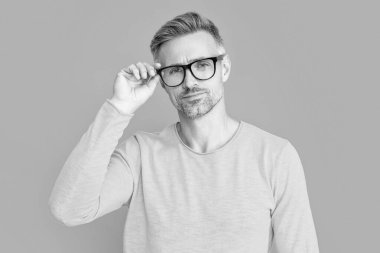 mature man look in eyewear on background. photo of man look in eyewear. man look in eyewear isolated on blue. man look in eyewear at studio.