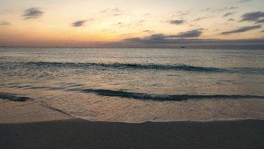 beautiful sunrise with sea water on the summer beach.