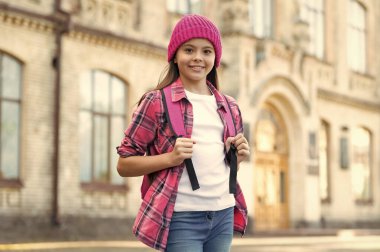 Happy teen girl back-to-school outdoors, education.