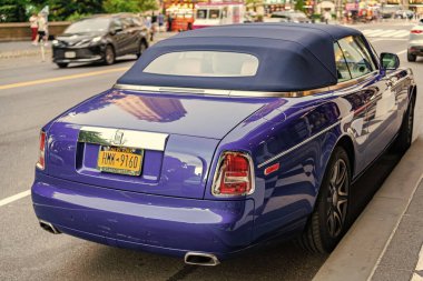 New York, ABD - 7 Temmuz 2023: 2008 Rolls-Royce Phantom Drophead Coupe mavi araba park edilmiş arka köşe manzarası.