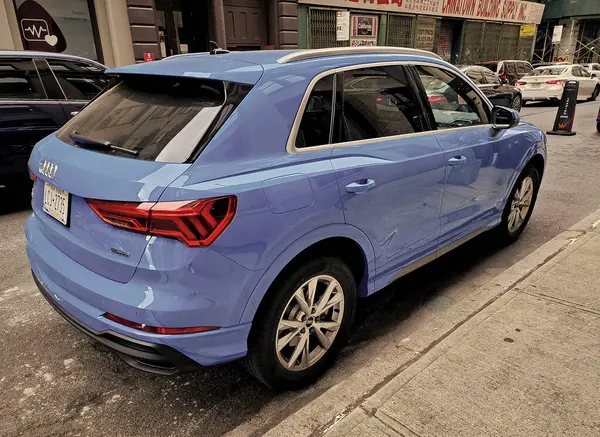 stock image New York City, USA - June 04, 2023: Audi Q3 Sportback SUV light blue car rear passenger side view parked.