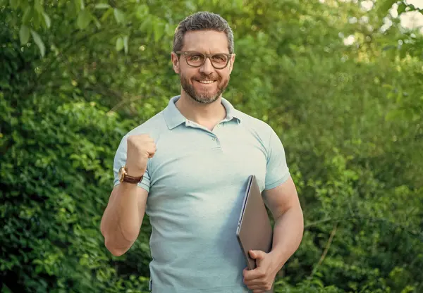 Stock image photo of happy business manager freelancing on pc. business manager freelancing. business manager freelancing outdoor. business manager freelancing online.