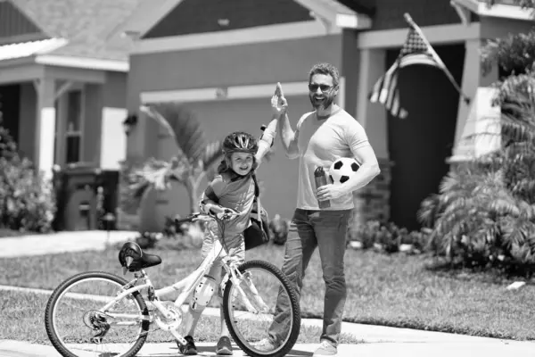 stock image happy father guiding son first bike ride. Father and son sharing biking adventure. father and son navigate the path together. happy family. Father and son enjoying a ride together.