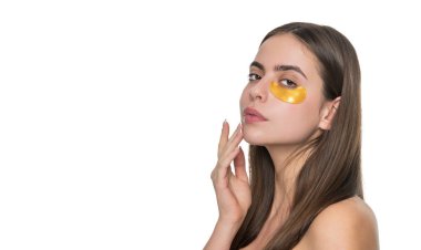 Göz altı nemlendirici bantlı cilt. Göz altı yamaları kullanan genç bir kadın, kopyalama alanı. Göz bantlı güzel bir kadın mükemmel bir cilde sahip. Kolajen hidrojel göz bantları. Günlük uygula.